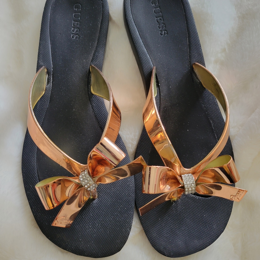 GUESS Women's Black Flip Flops with Rose Gold Bow Accent
